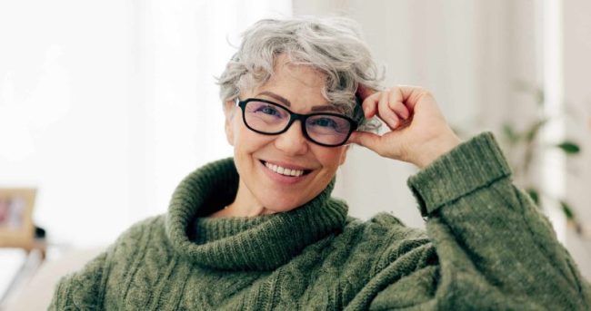 Happy,,Face,And,Senior,Woman,On,Sofa,To,Relax,In Dental Implants in San Francisco