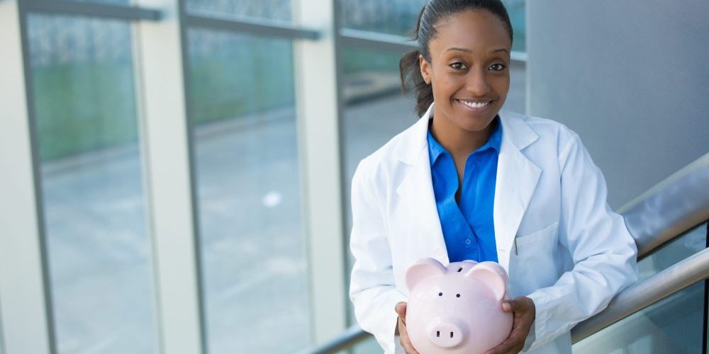 Closeup,Portrait,,Healthcare,Professional,Holding,Piggy,Bank,Isolated,Indoors,Clinic Affordable Dentist San Francisco