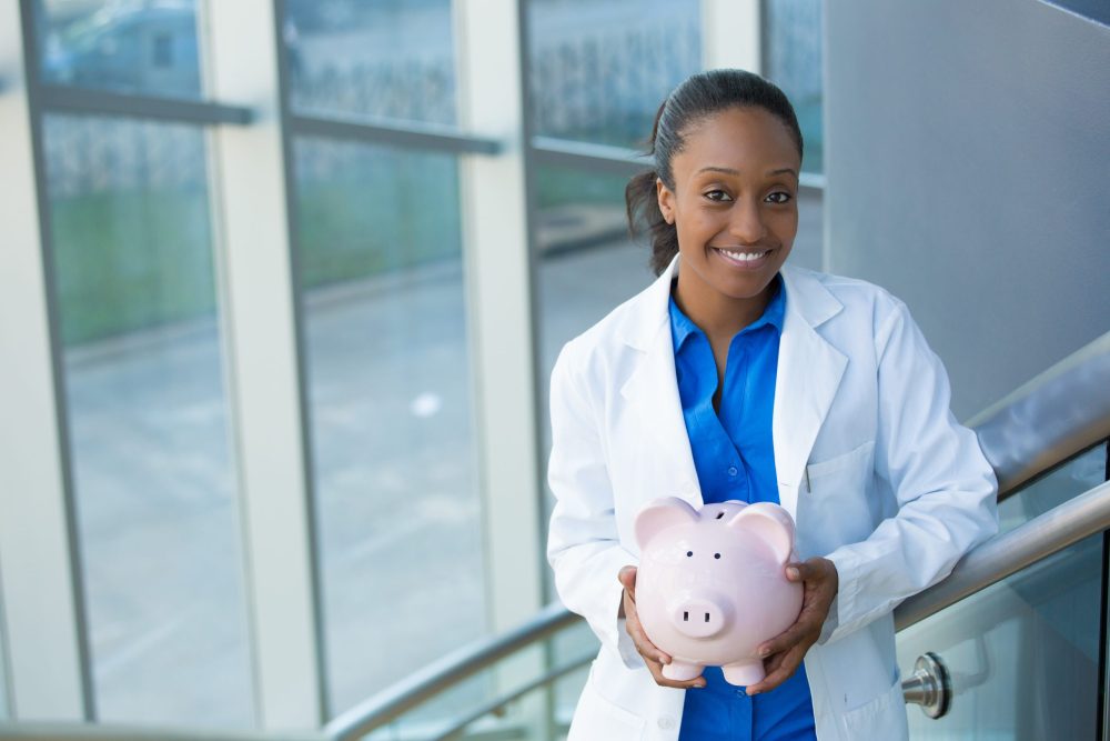 Closeup,Portrait,,Healthcare,Professional,Holding,Piggy,Bank,Isolated,Indoors,Clinic Affordable Dentist San Francisco